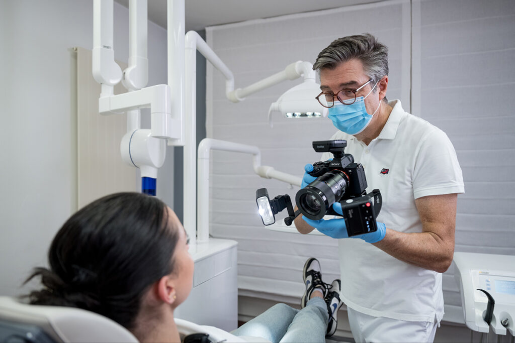 A dentist using Godox MF12-DK1 dental photography flash kit