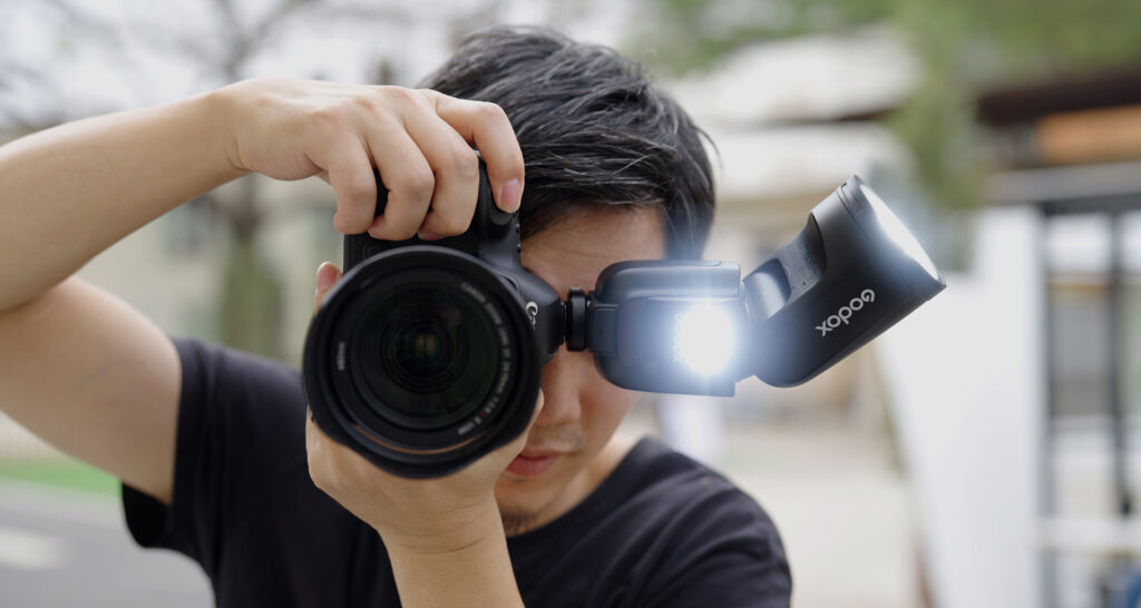 Photographer shooting with Godox V1Pro round head camera flash 