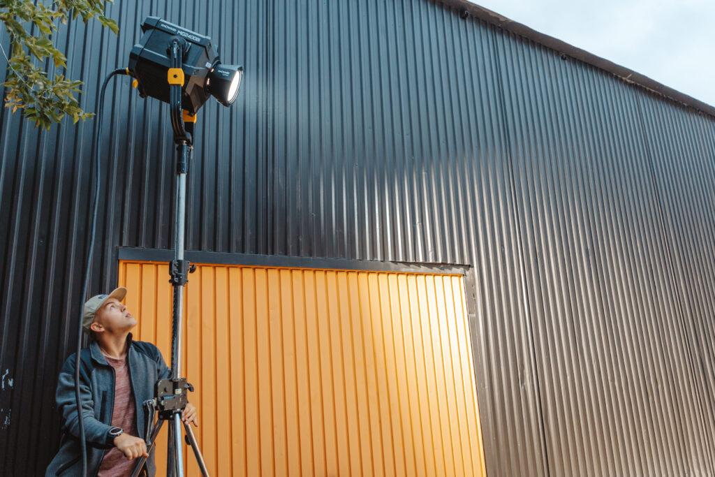 a lighting technician setting up the Godox MG2400Bi LED light