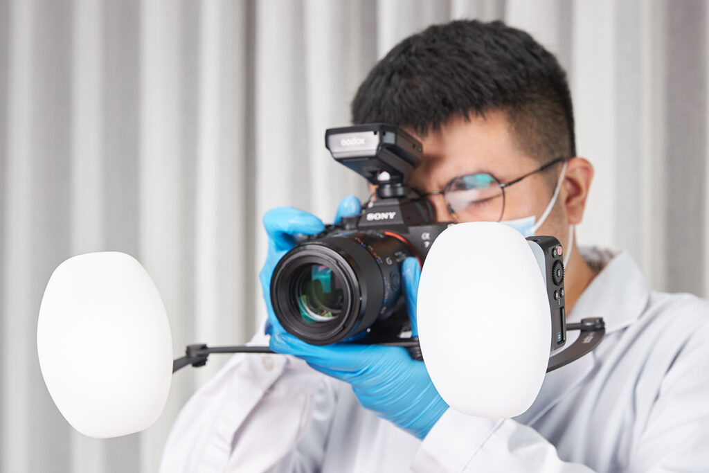 A dentist using Godox MF12-DK1 dental photography flash kit with diffusers 