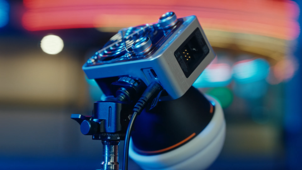 Zhiyun Molus X60 pocket COB LED light mounted on a tripod with DC power adapter plugged in