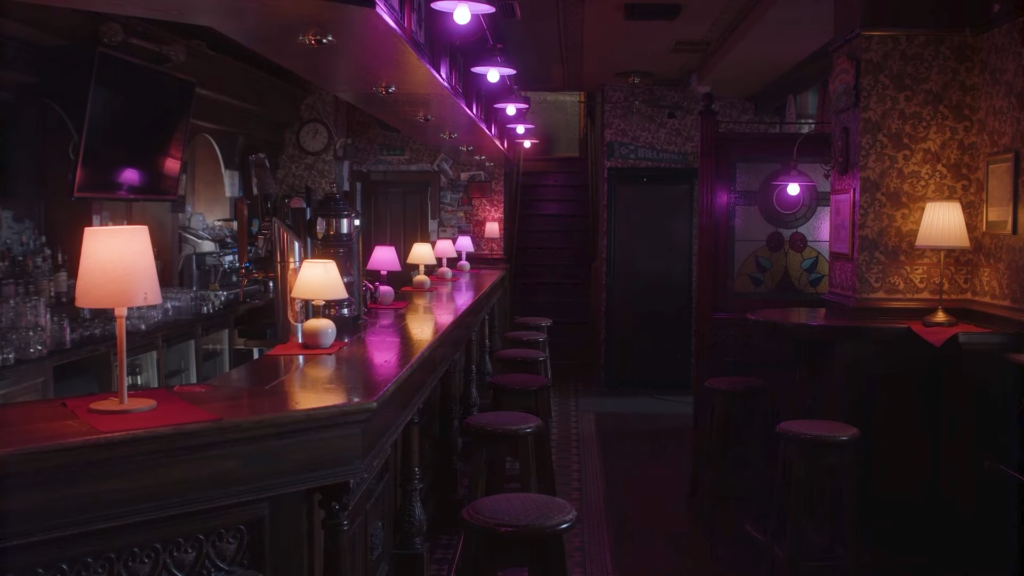 Astera LunaBulb RGB LED cine light bulb on set in a bar