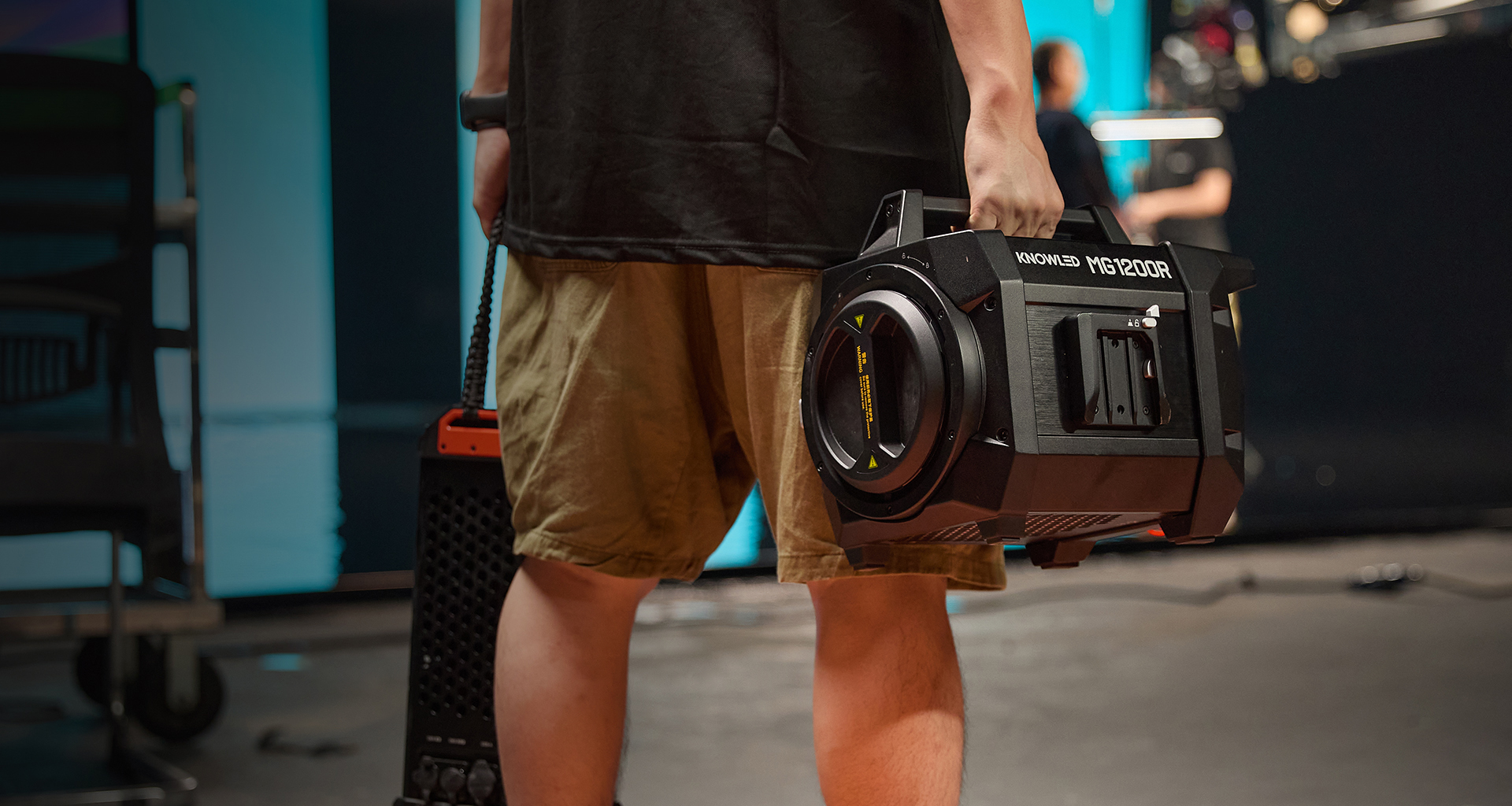 Godox KNOWLED MG1200R professional production full-color RGB COB LED light carried by a lighting technician