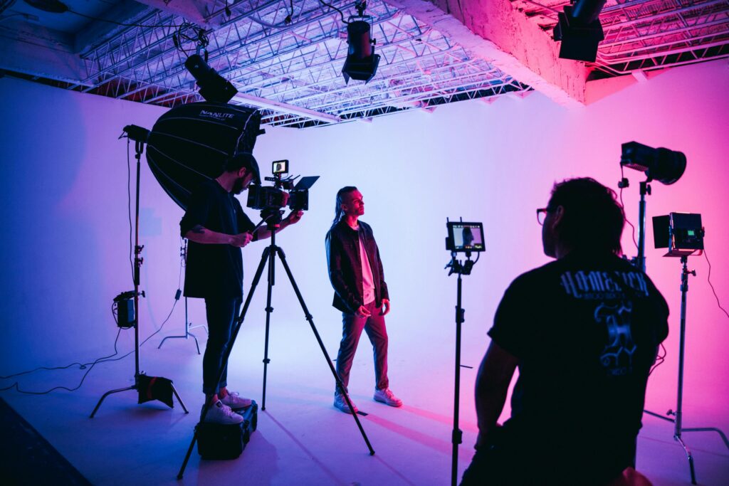 Professional filmmaking music video set with crew, cameras and lighting