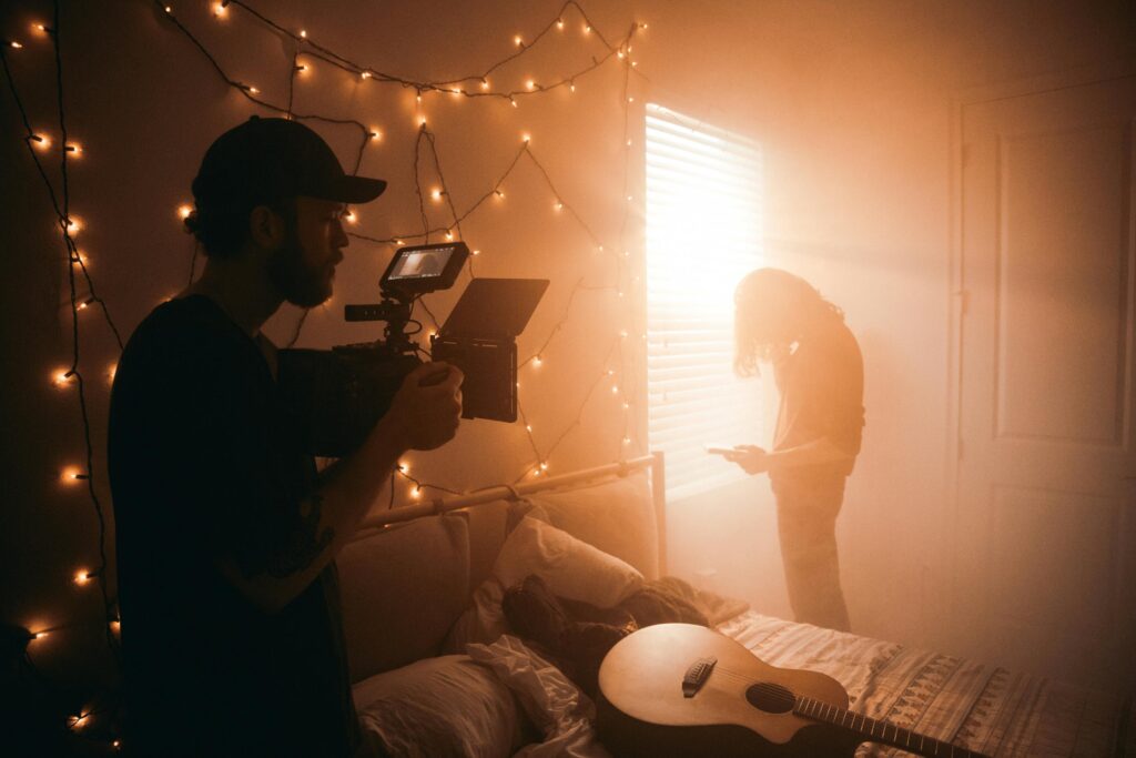 Cameraman recording a video in a hazy bedroom