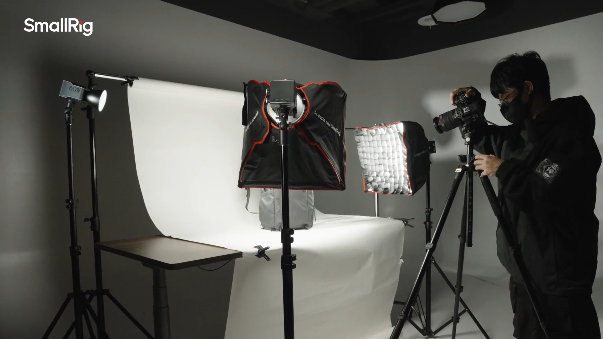 Photographer shooting product images using SmallRig RC 60C COB RGB LED video light on white background in a studio